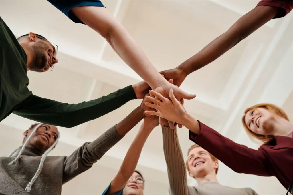 A team putting their hands together