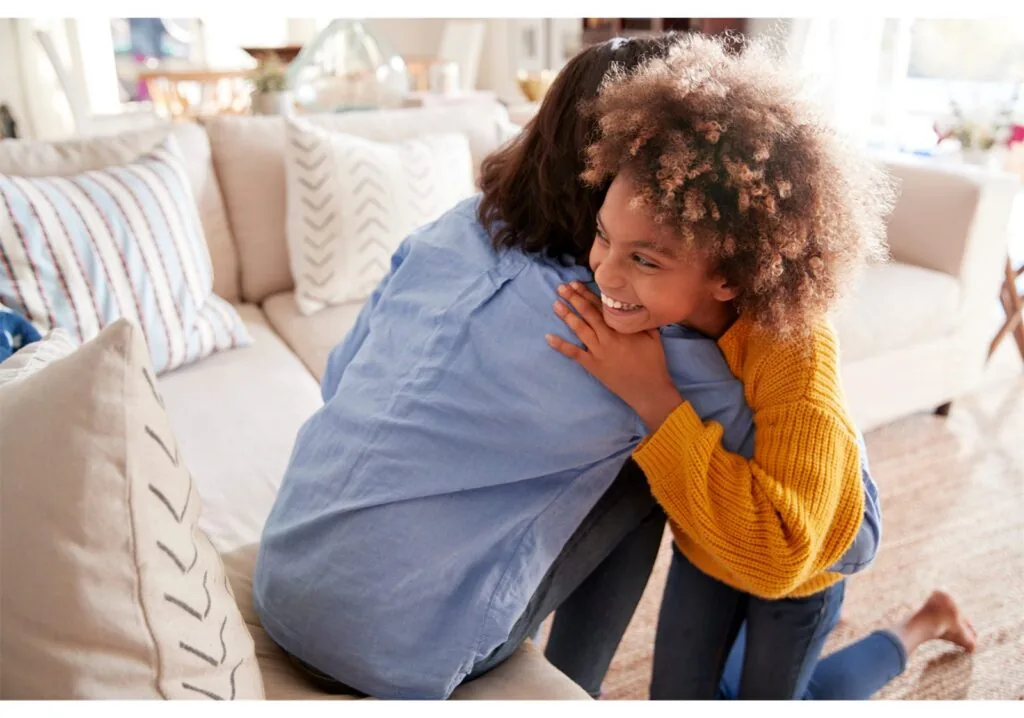 Two young people relaxing together on a sofa at home