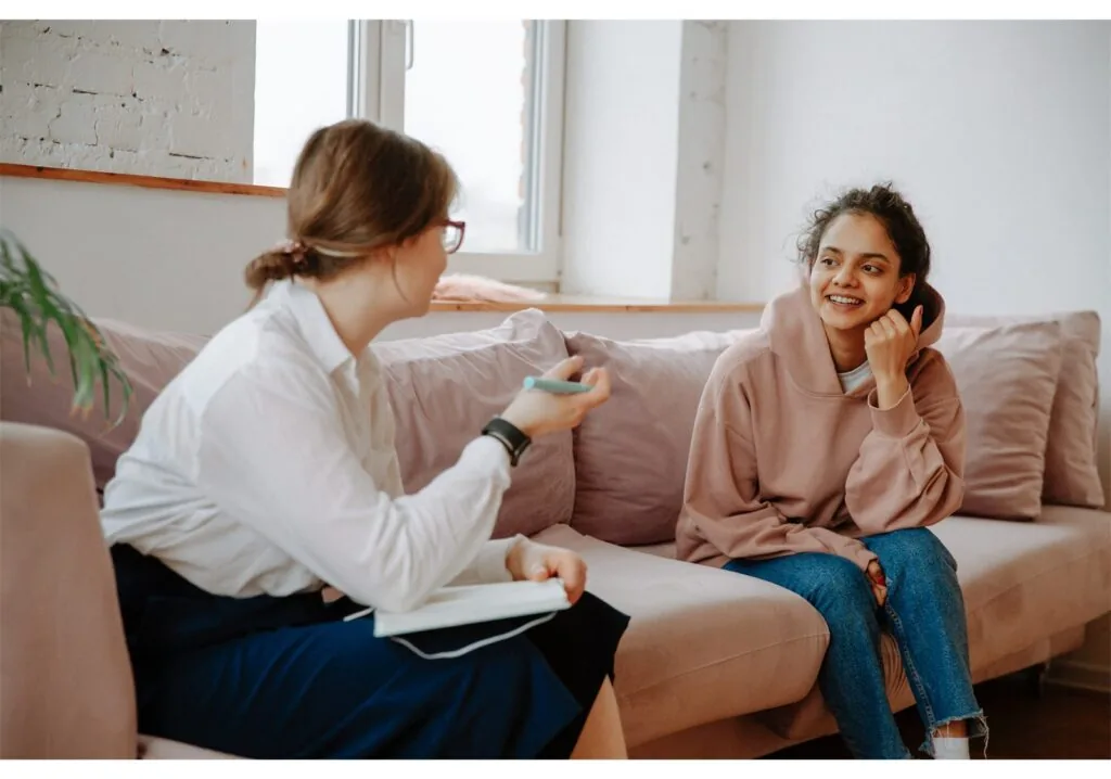 A keyworker and a young person talking one to one in a calm setting